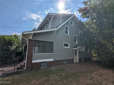View of side of home featuring a lawn