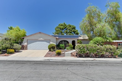 View of front of property featuring a garage, sola