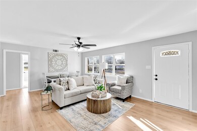 Living room with light wood finished floors, a cei