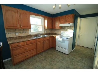 Kitchen. Door ahead leads to 2-car garage, door to