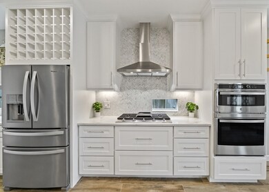 Packed with features, including a vent hood and oven-microwave combo!  All appliances are stainless steel and installed 2021.  This cooktop is even Bluetooth enabled - control the height of the flame right from your phone!