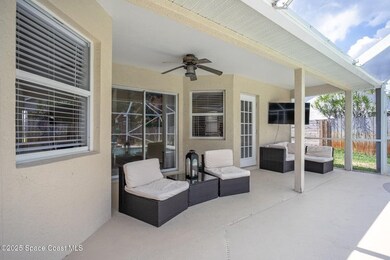 View of patio with an outdoor living space and a ceiling fan