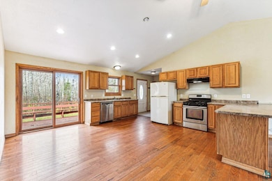 Kitchen with high vaulted ceiling, sink, stainless