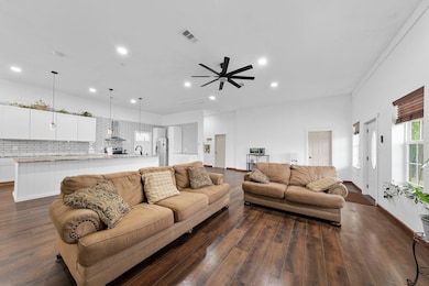 Living room with recessed lighting, visible vents,