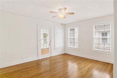 Spare room featuring baseboards, light wood-style 