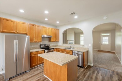 Kitchen featuring visible vents, arched walkways, 