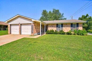 Single story home featuring a garage and a front y