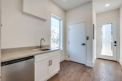 Kitchen with a wealth of natural light, white cabi