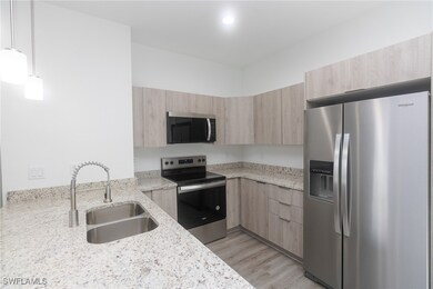 Kitchen with stainless steel appliances, light bro