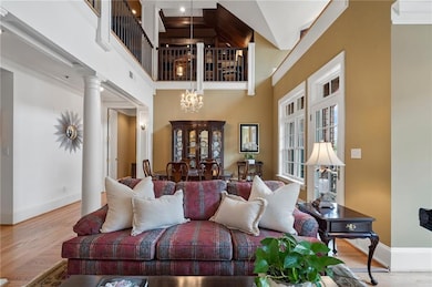 Living area featuring an inviting chandelier, wood
