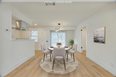 Dining room featuring a notable chandelier and light hardwood / wood-style floors
