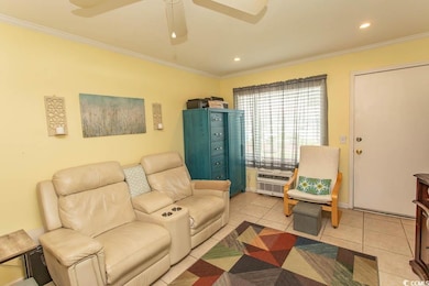 Living area featuring ornamental molding, light tile patterned floors, ceiling fan, recessed lighting, and a wall mounted AC