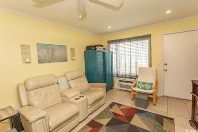 Living area featuring ornamental molding, light tile patterned floors, ceiling fan, recessed lighting, and a wall mounted AC