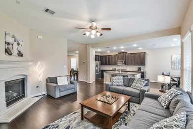 Living room with fireplace open to breakfast nook and kitchen