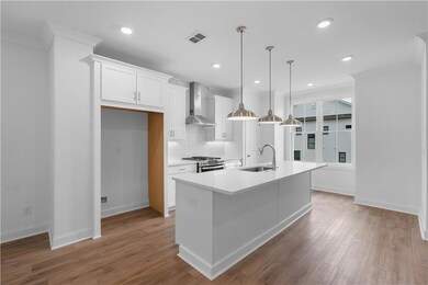 kitchen - white cabinets with quartz countertops, pendent lighting, single bowl sink - *pictures represent a previously built home * photos are for representation only