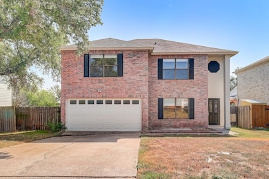Traditional-style home with brick siding, a garag
