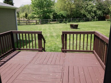 Large deck overlooking fenced back yard