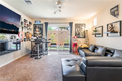 Living area featuring carpet flooring and baseboar