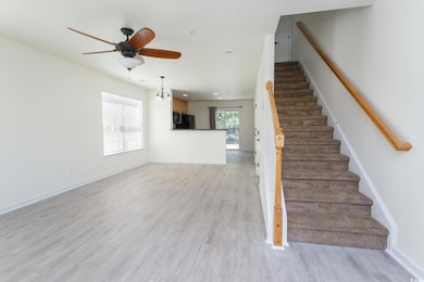 Stairway featuring wood finished floors, ceiling fan, a chandelier, and recessed lighting
