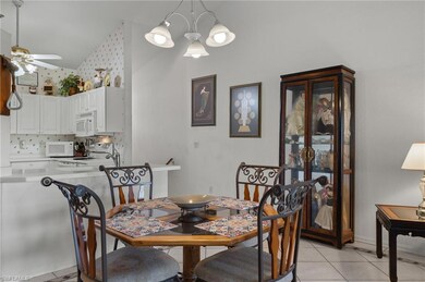 Dining space with ceiling fan with notable chandel