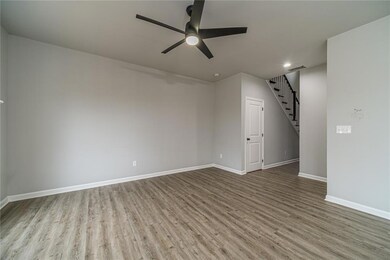 From the kitchen looking back to the front door and staircase to the 3 bedrooms.