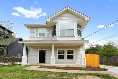 View of front of home with covered porch and fence