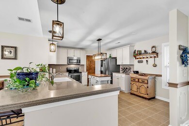 Kitchen with stainless steel appliances, a peninsu