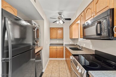 Kitchen with baseboards, light tile patterned floo