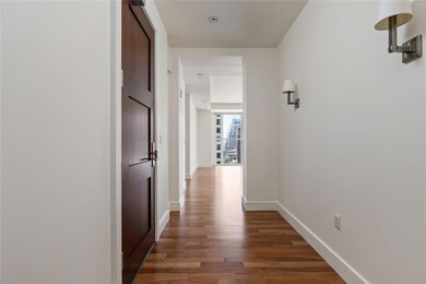 Corridor with wood finished floors and baseboards