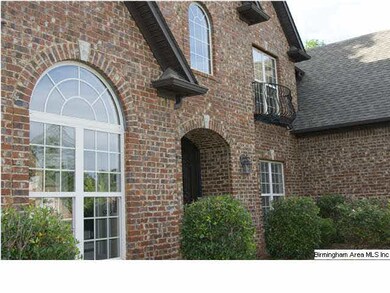 FRONT ENTRANCE WITH IRON RAILINGS AND ARCHED WINDO