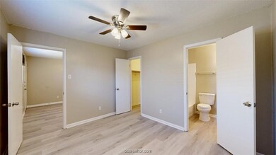 Unfurnished bedroom featuring a ceiling fan, a wal