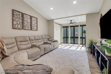 Living room featuring ceiling fan, lofted ceiling,