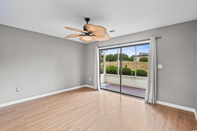 Unfurnished room with baseboards, wood finished floors, ceiling fan, and a textured ceiling