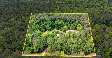 Aerial view of property's location featuring a forest and property parcel outlined