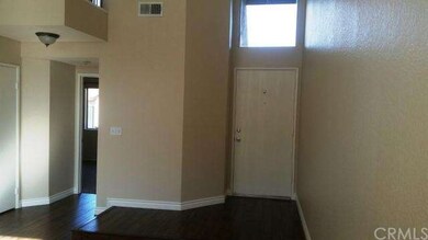 VIEW OF ENTRY FROM LIVING ROOM - NOTE MANY SKYLIGH
