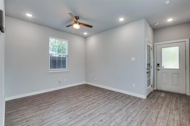 Entrance and living room with ceiling fan and ligh
