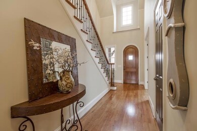 The foyer is 15x9.3 with 20 foot ceilings surrounded by rich hardwood floors. 