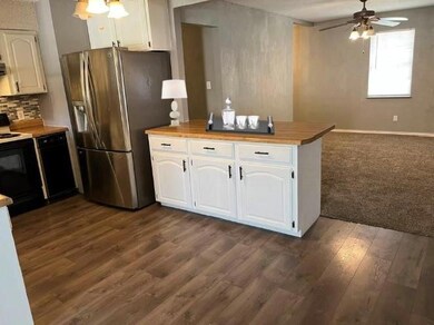 Kitchen UPDATED with glass backsplash, butcher block counters & luxury vinyl floors. Trash compactor, breakfast bar & large pantry. Open to Family Room.