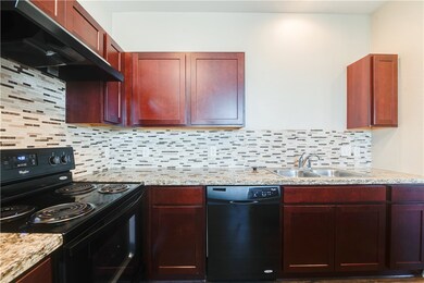 Kitchen with range hood, sink, decorative backspla