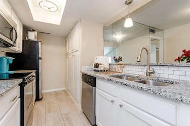 Kitchen featuring visible vents, white cabinets, a