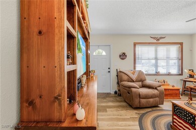 Living room with light wood-style flooring and a t
