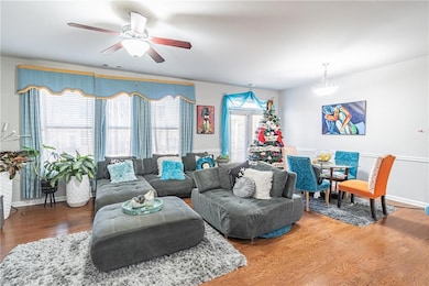 Living room with hardwood / wood-style flooring an
