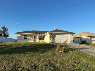 Ranch-style home with a garage and a front lawn