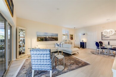 Living room featuring an inviting chandelier and w