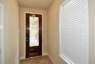 Gorgeous entry with wood door and leaded glass ins