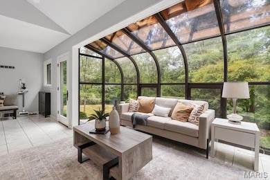 Sun room with a door leasing to exterior living space.