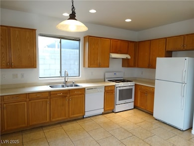 Kitchen featuring brown cabinets, under cabinet ra