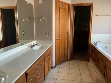 The master bath has double sinks, a whirlpool tub 
