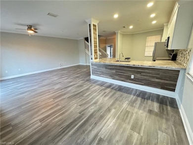 Kitchen with ornamental molding, wood finished flo