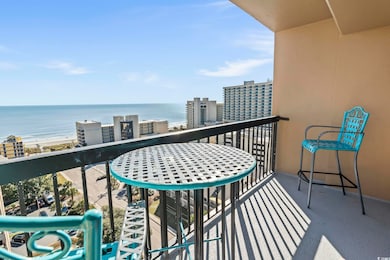Balcony featuring a water view and a beach view